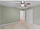 Bedroom featuring green walls, ceiling fan, and a closet at 5929 Quail Hollow Rd # B, Charlotte, NC 28210