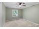Bedroom features green walls, natural light, and neutral carpet at 5929 Quail Hollow Rd # B, Charlotte, NC 28210