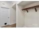 Walk-in closet with wood shelf and rack in neutral color scheme, featuring a wood-look floor at 5929 Quail Hollow Rd # B, Charlotte, NC 28210