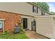 Townhome exterior with brick and vinyl siding, gated patio, and well-maintained landscaping at 5929 Quail Hollow Rd # B, Charlotte, NC 28210