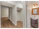Hallway featuring wood floors, built-in shelving and an adjacent half bathroom with updated sink at 5929 Quail Hollow Rd # B, Charlotte, NC 28210