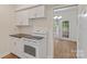 Well-lit kitchen with white appliances, white cabinets, and a view to the outside through french doors at 5929 Quail Hollow Rd # B, Charlotte, NC 28210