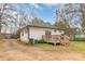 Back exterior view features a wooden deck, siding, and a spacious backyard at 65 Franklin St, Wadesboro, NC 28170