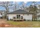 Back of home with a wooden deck and sliding glass door to backyard at 65 Franklin St, Wadesboro, NC 28170