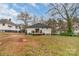 Back of home with a wooden deck and sliding glass door, and a spacious yard at 65 Franklin St, Wadesboro, NC 28170