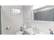 Bright bathroom featuring a white vanity, mirror, and a window for natural light at 65 Franklin St, Wadesboro, NC 28170