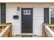 Close-up of the front door, showcasing the house number, mailbox, and exterior lighting at 65 Franklin St, Wadesboro, NC 28170