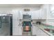 Bright kitchen boasts white cabinets, stainless steel appliances, and ample countertop space at 65 Franklin St, Wadesboro, NC 28170