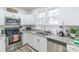 Modern kitchen features white cabinets, granite countertops, stainless steel appliances, and a double sink at 65 Franklin St, Wadesboro, NC 28170