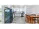 Open kitchen with white cabinetry, a stainless steel refrigerator, and a dining area at 65 Franklin St, Wadesboro, NC 28170
