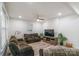Comfortable living room with brown sofa set, entertainment center and modern ceiling fan at 65 Franklin St, Wadesboro, NC 28170