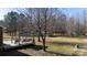 Deck with pergola, seating area, and storage shed in a wooded backyard at 665 Edwards Rd, Fort Lawn, SC 29714