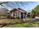 Brick ranch house with landscaped yard and teal front door at 665 Edwards Rd, Fort Lawn, SC 29714