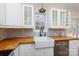 White shaker cabinets, butcher block countertops, farm sink at 665 Edwards Rd, Fort Lawn, SC 29714