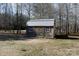 Wooden storage shed with metal roof in a wooded area at 665 Edwards Rd, Fort Lawn, SC 29714
