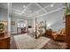 Serene main bedroom with coffered ceiling, hardwood floors, and a cozy sitting area, creating a peaceful retreat at 736 Amalfi Dr, Davidson, NC 28036