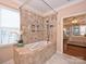 Main bathroom featuring a tile shower with a bathtub and a view into the bedroom at 9038 Elrose Pl, Charlotte, NC 28277