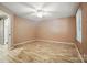 Spacious bedroom with hardwood floors, neutral walls, ceiling fan, and a ensuite bath at 9108 Nolley Ct # B, Charlotte, NC 28270