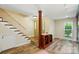 Welcoming foyer featuring hardwood floors, staircase, wine storage, and natural light at 9108 Nolley Ct # B, Charlotte, NC 28270