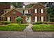 Charming brick home featuring a well-manicured lawn, dark shutters, and a welcoming walkway at 9108 Nolley Ct # B, Charlotte, NC 28270
