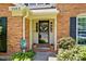 Inviting front porch featuring a decorative door, potted plants, and a welcome sign at 9108 Nolley Ct # B, Charlotte, NC 28270