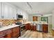 Modern kitchen featuring stainless steel appliances, wooden cabinets, mosaic backsplash, and hard wood floors at 9108 Nolley Ct # B, Charlotte, NC 28270