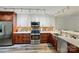 Modern kitchen with stainless steel appliances, two-tone cabinetry, and stylish backsplash at 9108 Nolley Ct # B, Charlotte, NC 28270
