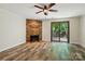 Spacious living room with a decorative stone fireplace and sliding glass doors at 9108 Nolley Ct # B, Charlotte, NC 28270