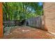 Private brick patio enclosed by a wooden fence and mature trees for a secluded outdoor living space at 9108 Nolley Ct # B, Charlotte, NC 28270