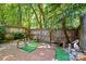 Enclosed brick patio with mature trees and manicured decorative landscaping elements at 9108 Nolley Ct # B, Charlotte, NC 28270