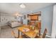 Open-concept dining area with a wooden table and chairs connecting to the kitchen and living room at 101 Arbridge Ct, Mount Holly, NC 28120