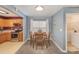 Cozy dining area with a wooden table set, view of the kitchen, and ample natural light at 101 Arbridge Ct, Mount Holly, NC 28120