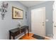 Welcoming entryway featuring a dark console table, decorative wall art, and wood flooring at 101 Arbridge Ct, Mount Holly, NC 28120