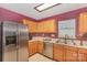 Well-lit kitchen with stainless steel appliances, ample cabinet space, and neutral countertops at 101 Arbridge Ct, Mount Holly, NC 28120