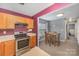 Open layout connecting the kitchen with stainless steel appliances to the inviting dining area at 101 Arbridge Ct, Mount Holly, NC 28120