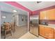 Open kitchen flows into the dining area, stainless steel refrigerator, and hardwood cabinets at 101 Arbridge Ct, Mount Holly, NC 28120