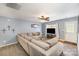 Spacious living room featuring a large sectional, ceiling fan, and an adjacent doorway at 101 Arbridge Ct, Mount Holly, NC 28120