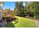 Green backyard with grass, a wooden fence, and a deck for leisure at 10120 Garman Hill Dr, Charlotte, NC 28214