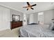 Spacious bedroom with a large bed, a dresser with mirror, and access to other rooms at 10120 Garman Hill Dr, Charlotte, NC 28214