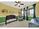 Charming Bedroom with a crib, comfy chair, and bright wall colors with playful decor at 10120 Garman Hill Dr, Charlotte, NC 28214