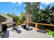 Outdoor deck area with a fire pit and grill perfect for entertainment with mature trees at 10120 Garman Hill Dr, Charlotte, NC 28214