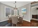 Cozy dining area with a round table, stylish chairs, a modern chandelier, and large windows at 10120 Garman Hill Dr, Charlotte, NC 28214