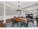 Elegant dining room with hardwood floors, a chandelier and office in the background at 10120 Garman Hill Dr, Charlotte, NC 28214