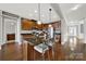 Spacious kitchen featuring dark cabinetry, granite countertops, an island with seating, and hardwood floors at 10120 Garman Hill Dr, Charlotte, NC 28214