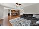 Open-concept living room with a view of the kitchen and staircase, hardwood floors, and natural light at 10120 Garman Hill Dr, Charlotte, NC 28214