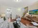 Living room with hardwood floors and view of kitchen and stairs at 1018 Archibald Ave, Fort Mill, SC 29708