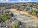 An aerial view of a golf course lined with houses and thick woods under a sky of clouds at 1019 Palmyra Dr, Tega Cay, SC 29708