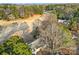 Aerial view of the home featuring mature trees, golf course, and wooded surroundings at 1019 Palmyra Dr, Fort Mill, SC 29708