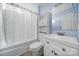 Bathroom featuring neutral paint, white cabinets, and a shower-tub combo at 1019 Palmyra Dr, Tega Cay, SC 29708