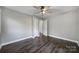 Bedroom with hardwood floors, bright walls, and neutral trim at 1019 Palmyra Dr, Tega Cay, SC 29708